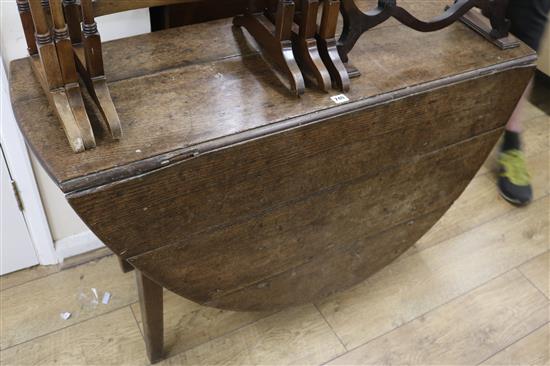 An oak oval drop-leaf table fitted single drawer, W.140cm (with leaves extended)